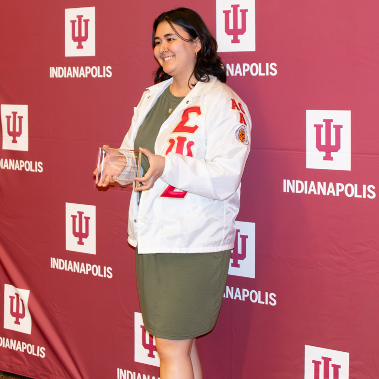 A woman holding an award.