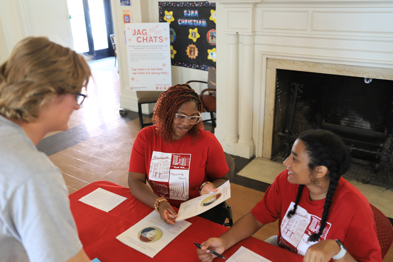 Student employees tabling for an event through Housing and Residence Life.